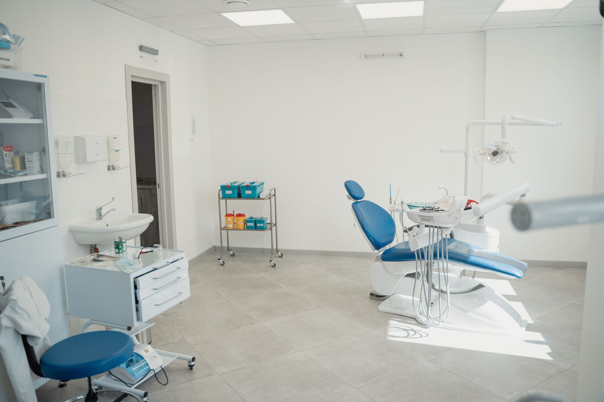 Bright and clean dental clinic interior showcasing a dental chair and equipment.